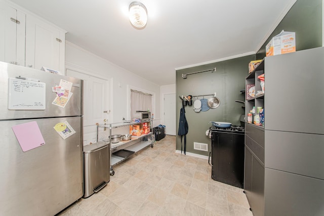 414 W Summit St, Ann Arbor, MI 48103 - kitchen with freestanding refrigerator, ornamental molding, baseboards, and white cabinetry