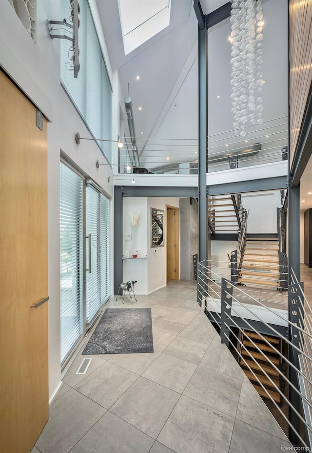 1363 Forest Bay Dr, Waterford, MI 48328 - hallway with a towering ceiling, a skylight, stairway, and tile patterned flooring