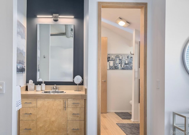 1363 Forest Bay Dr, Waterford, MI 48328 - bathroom featuring vanity, toilet, wood finished floors, and vaulted ceiling