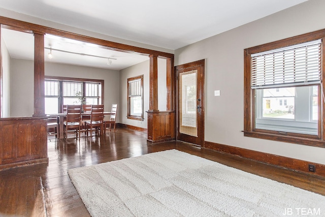 200 W 21st St, Holland, MI 49423 - foyer entrance featuring decorative columns, dark wood-type flooring, and baseboards