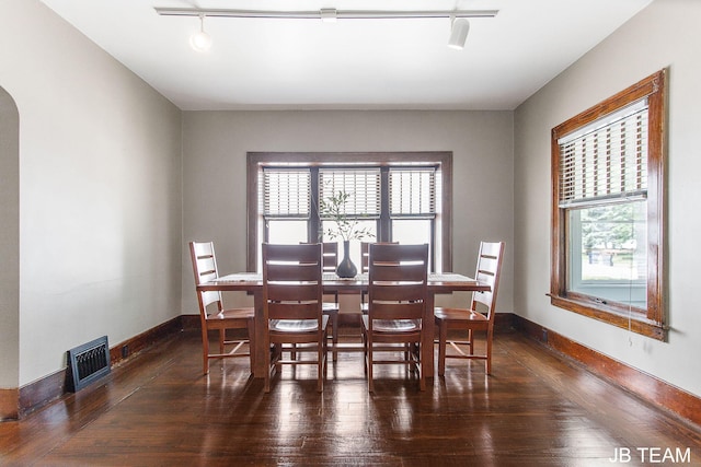 200 W 21st St, Holland, MI 49423 - dining room with wood-type flooring, baseboards, arched walkways, and track lighting