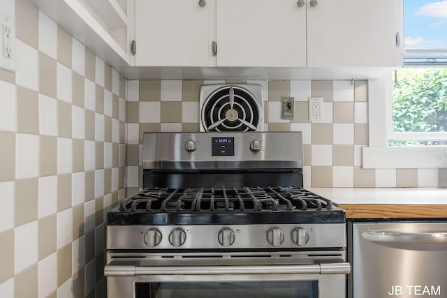 200 W 21st St, Holland, MI 49423 - kitchen with stainless steel appliances, light countertops, tasteful backsplash, and white cabinetry
