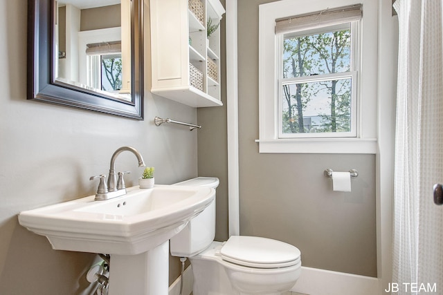 200 W 21st St, Holland, MI 49423 - bathroom featuring toilet, plenty of natural light, and a sink