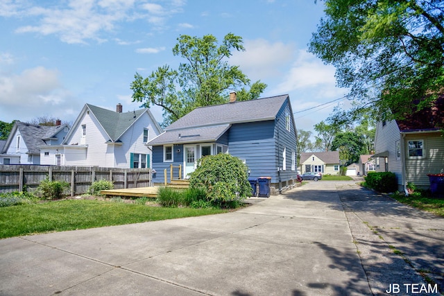 200 W 21st St, Holland, MI 49423 - rear view of property featuring driveway, a residential view, and a chimney