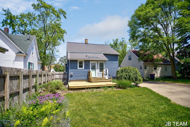 200 W 21st St, Holland, MI 49423 - back of property featuring a chimney, roof with shingles, and a wooden deck