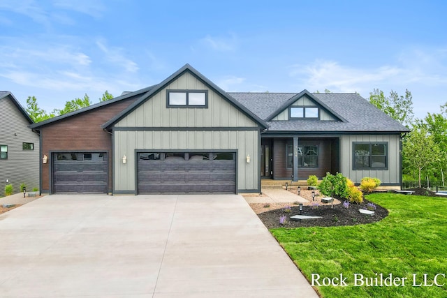 7134 Sugar Maple Dr, Hudsonville, MI 49426 - view of front of house with a garage, concrete driveway, a front yard, roof with shingles, and board and batten siding