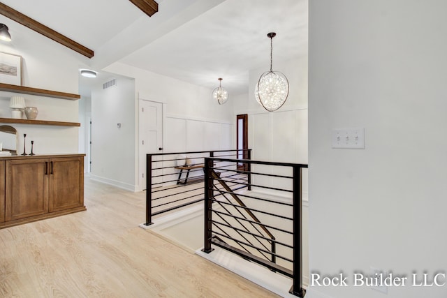 7134 Sugar Maple Dr, Hudsonville, MI 49426 - hall with an upstairs landing, light wood-style flooring, beam ceiling, and a chandelier