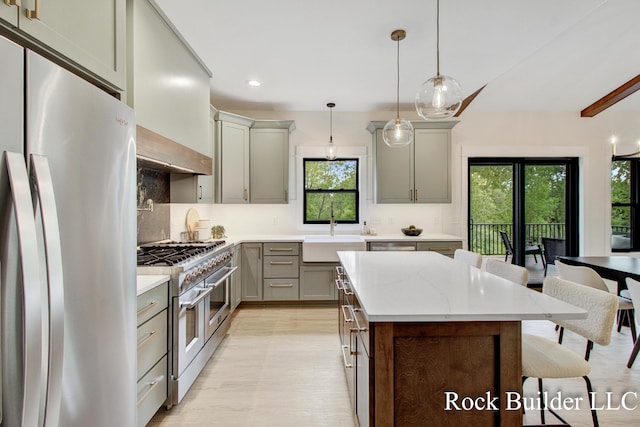 7134 Sugar Maple Dr, Hudsonville, MI 49426 - kitchen with appliances with stainless steel finishes, a sink, gray cabinets, decorative backsplash, and light wood finished floors