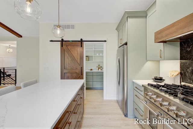 7134 Sugar Maple Dr, Hudsonville, MI 49426 - kitchen featuring cooktop, a barn door, backsplash, custom exhaust hood, and light wood-style flooring