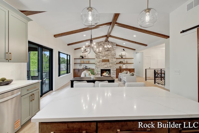 7134 Sugar Maple Dr, Hudsonville, MI 49426 - kitchen with stainless steel dishwasher, recessed lighting, light wood-type flooring, decorative light fixtures, and a stone fireplace