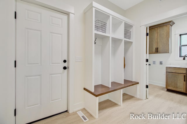7134 Sugar Maple Dr, Hudsonville, MI 49426 - mudroom with light wood-style floors and baseboards