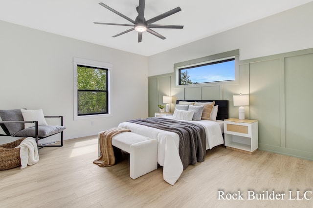7134 Sugar Maple Dr, Hudsonville, MI 49426 - bedroom with light wood finished floors, a decorative wall, and ceiling fan