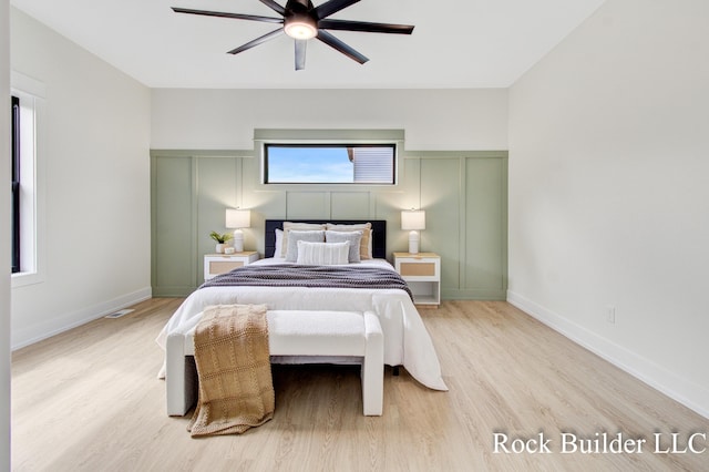 7134 Sugar Maple Dr, Hudsonville, MI 49426 - bedroom with light wood-style flooring, a decorative wall, and ceiling fan