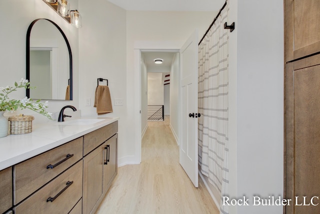 7134 Sugar Maple Dr, Hudsonville, MI 49426 - bathroom with vanity, wood finished floors, and baseboards