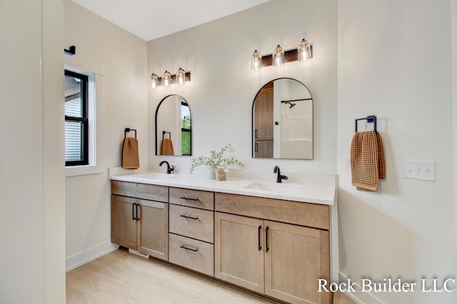 7134 Sugar Maple Dr, Hudsonville, MI 49426 - full bathroom with double vanity, baseboards, and wood finished floors