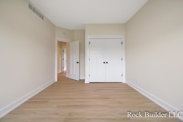 7134 Sugar Maple Dr, Hudsonville, MI 49426 - unfurnished bedroom with baseboards, light wood-style flooring, and a closet