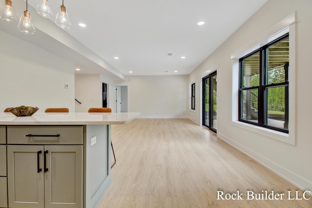 7134 Sugar Maple Dr, Hudsonville, MI 49426 - kitchen with light wood-style floors, recessed lighting, light countertops, decorative light fixtures, and baseboards