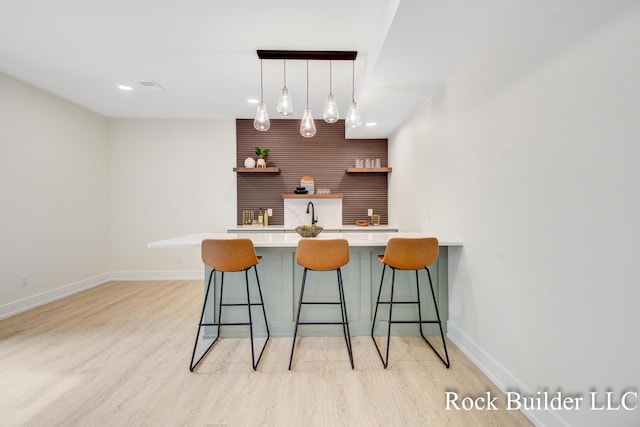 7134 Sugar Maple Dr, Hudsonville, MI 49426 - indoor wet bar with light wood-style flooring, baseboards, decorative light fixtures, and recessed lighting