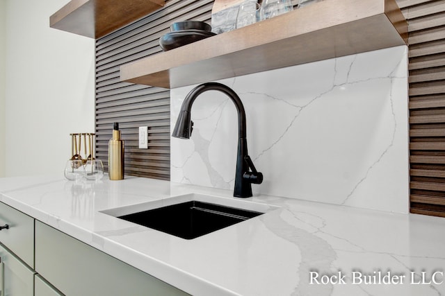 7134 Sugar Maple Dr, Hudsonville, MI 49426 - kitchen view of a sink, light stone countertops, decorative backsplash, and green cabinetry