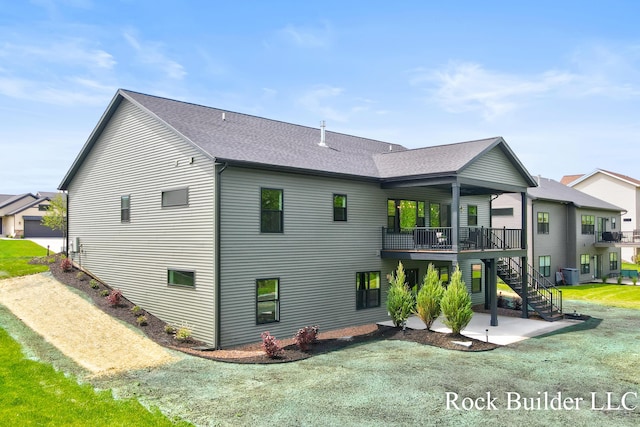 7134 Sugar Maple Dr, Hudsonville, MI 49426 - rear view of house featuring stairs, a patio, a shingled roof, and a deck
