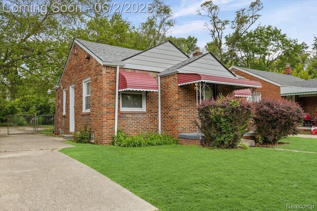 18697 Sunderland Rd, Detroit, MI 48219 - view of front of home featuring a gate, brick siding, a chimney, and roof with shingles