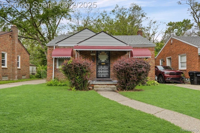 18697 Sunderland Rd, Detroit, MI 48219 - bungalow with a front lawn, a chimney, brick siding, and a shingled roof