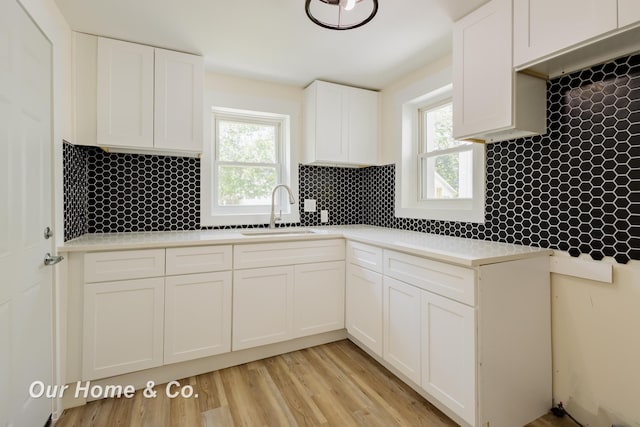 337 N Fairview Ave, Lansing, MI 48912 - kitchen featuring a sink, plenty of natural light, and white cabinetry