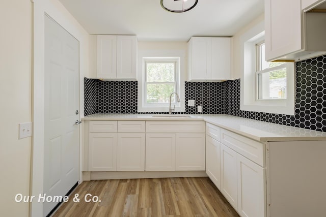 337 N Fairview Ave, Lansing, MI 48912 - kitchen with a sink, tasteful backsplash, and white cabinets