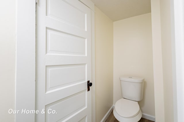 337 N Fairview Ave, Lansing, MI 48912 - bathroom with baseboards, toilet, wood finished floors, and a textured ceiling