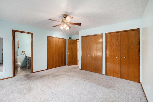 6400 Chestnut Hill Ct, Clarkston, MI 48346 - unfurnished bedroom with multiple closets, carpet floors, ensuite bathroom, baseboards, and ceiling fan