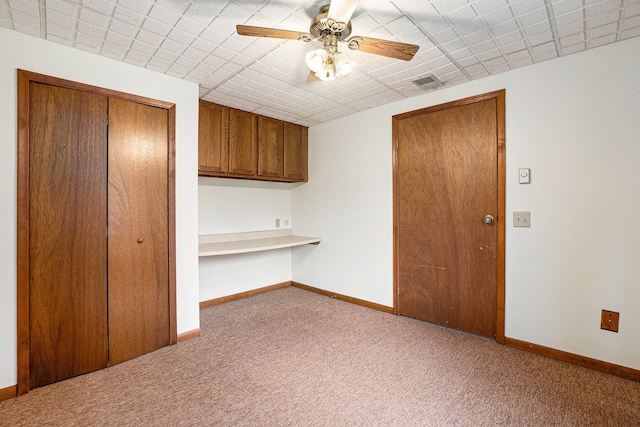 6400 Chestnut Hill Ct, Clarkston, MI 48346 - carpeted spare room with built in study area, ceiling fan, and baseboards