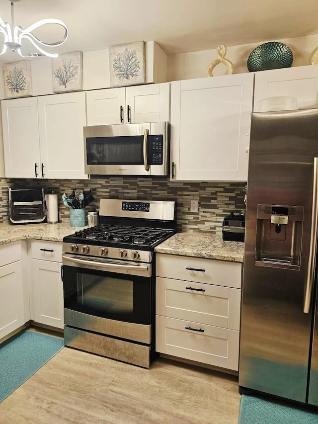 3062 Roundtree Blvd, Ypsilanti, MI 48197 - kitchen with appliances with stainless steel finishes, white cabinetry, and backsplash