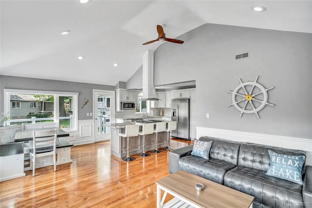 533 Bellevue Ave, Lake Orion, MI 48362 - living area with ceiling fan, wainscoting, light wood finished floors, high vaulted ceiling, and recessed lighting