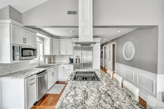 533 Bellevue Ave, Lake Orion, MI 48362 - kitchen with stainless steel appliances, light stone countertops, backsplash, light wood finished floors, and white cabinets