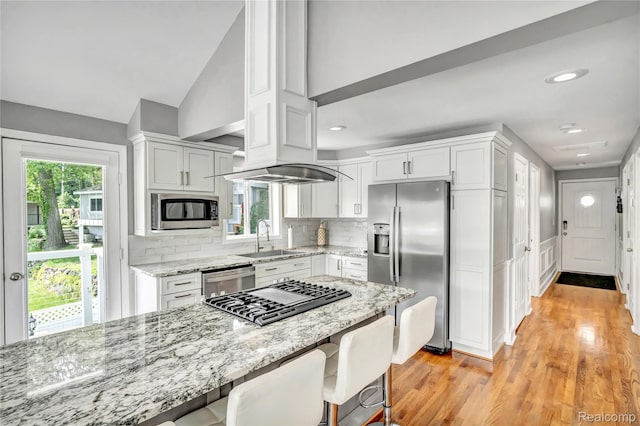 533 Bellevue Ave, Lake Orion, MI 48362 - kitchen featuring appliances with stainless steel finishes, white cabinets, tasteful backsplash, light wood finished floors, and vaulted ceiling