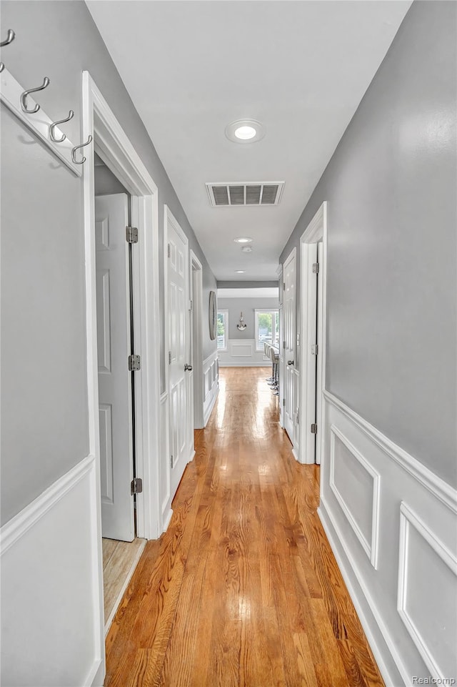 533 Bellevue Ave, Lake Orion, MI 48362 - hall featuring light wood-style floors, wainscoting, and a decorative wall