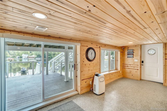 533 Bellevue Ave, Lake Orion, MI 48362 - entryway featuring wood ceiling, wooden walls, and speckled floor