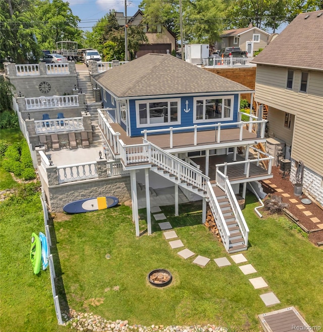 533 Bellevue Ave, Lake Orion, MI 48362 - back of house featuring stairs, a shingled roof, a yard, and a wooden deck