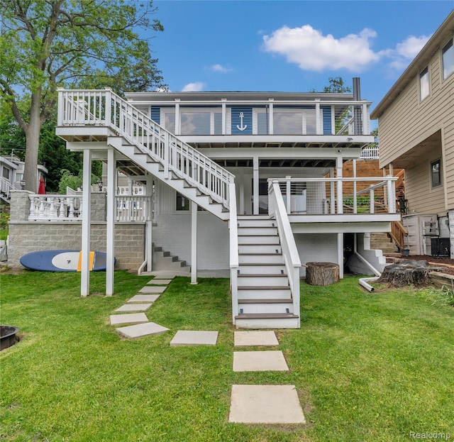 533 Bellevue Ave, Lake Orion, MI 48362 - back of property with stairway, a yard, and a wooden deck