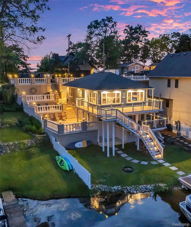 533 Bellevue Ave, Lake Orion, MI 48362 - rear view of property featuring stairway, a deck, an outdoor fire pit, and a yard