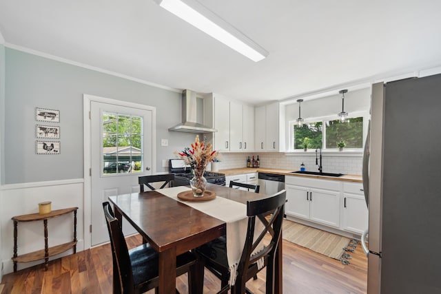 229 Water St, Grass Lake, MI 49240 - dining space with healthy amount of natural light, ornamental molding, and light wood-style floors