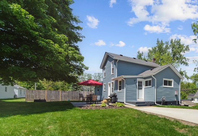 229 Water St, Grass Lake, MI 49240 - back of property with a chimney and a patio area