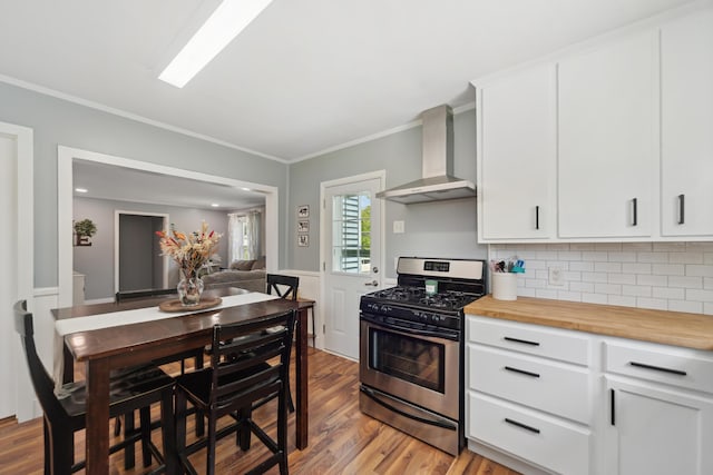 229 Water St, Grass Lake, MI 49240 - kitchen featuring stainless steel gas range, wall chimney range hood, light wood-style floors, ornamental molding, and tasteful backsplash
