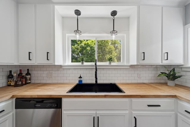 229 Water St, Grass Lake, MI 49240 - kitchen featuring wood counters, stainless steel dishwasher, a sink, and white cabinetry
