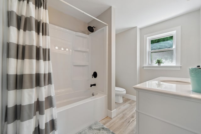229 Water St, Grass Lake, MI 49240 - bathroom with toilet, shower / tub combo with curtain, wood finished floors, vanity, and baseboards