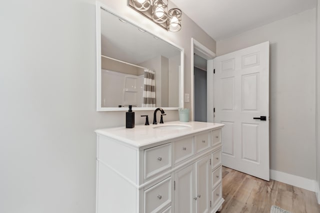 229 Water St, Grass Lake, MI 49240 - full bathroom featuring vanity, wood finished floors, a shower with curtain, and baseboards