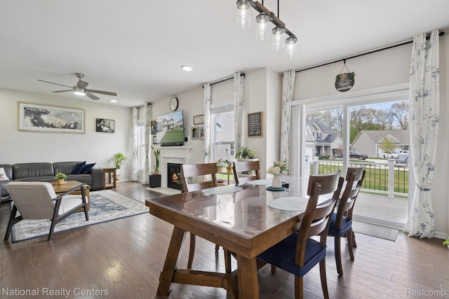 222 Quartz Way, White Lake, MI 48386 - dining area featuring ceiling fan, hardwood / wood-style flooring, a glass covered fireplace, recessed lighting, and baseboards