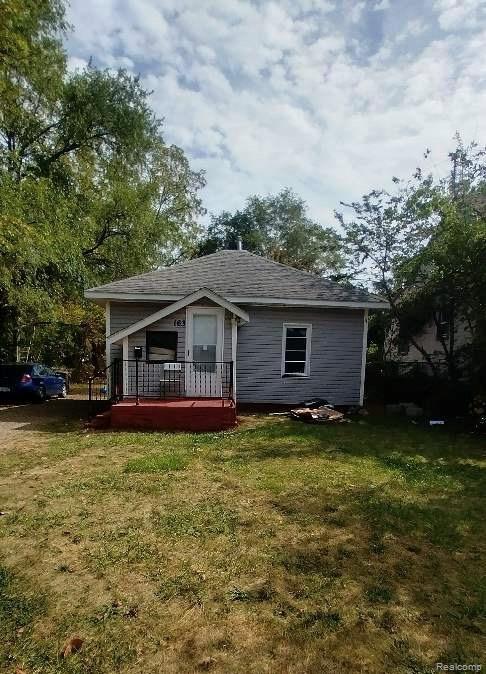 163 Seward St, Pontiac, MI 48342 - rear view of property with a deck and a yard