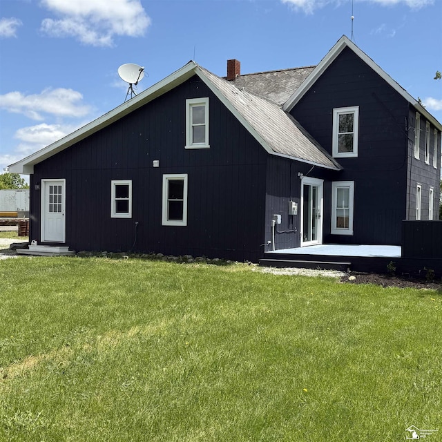 18200 Sherman, Milan, MI 48160 - rear view of property featuring a chimney and a yard