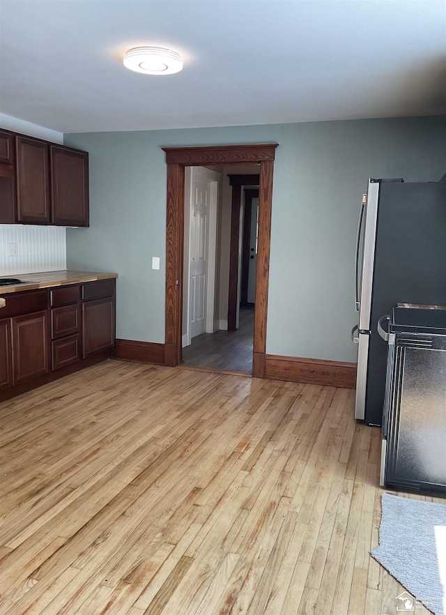 18200 Sherman, Milan, MI 48160 - kitchen featuring freestanding refrigerator, light wood-style floors, baseboards, and dark brown cabinets